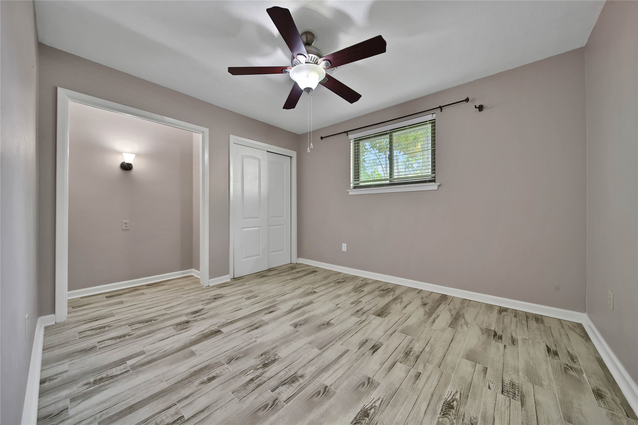 2006 Mermaid Lane Houston, TX 77062 - Photo 22 of 35 a view of an empty room with wooden floor and a ceiling fan
