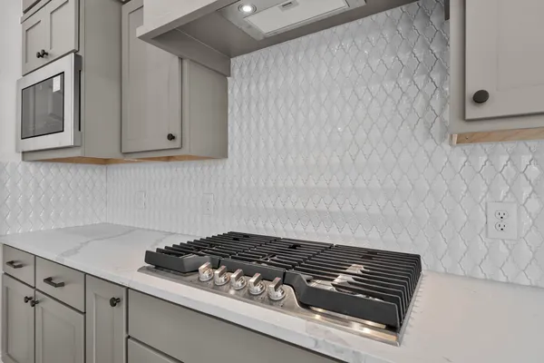 a stove top oven sitting inside of a kitchen
