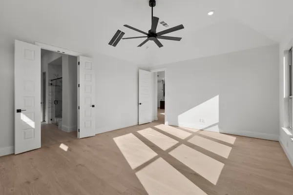 a bedroom with a bed and a ceiling fan