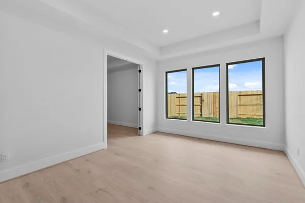 an empty room with windows and closet