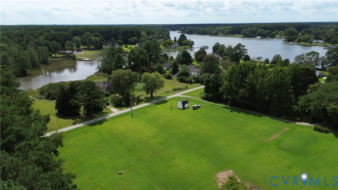Lot 4 Kayak Trail Mathews, VA 23109 - Photo 1 of 11 a view of a lake with a houses in the back