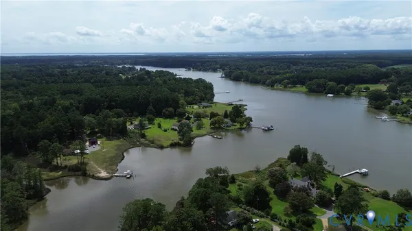 a view of a lake with houses in back