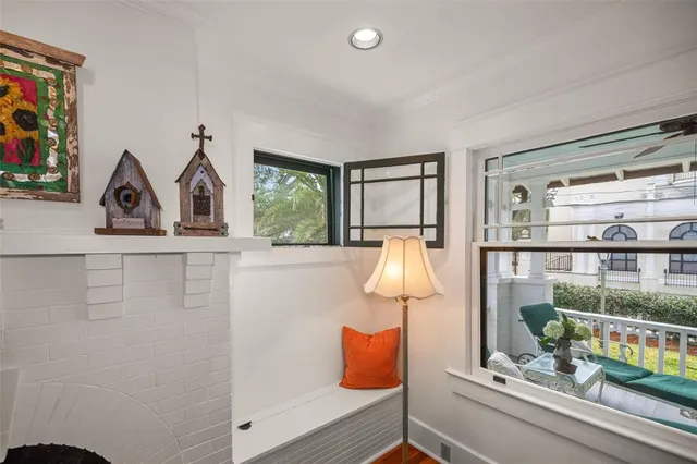 a kitchen with stainless steel appliances granite countertop a refrigerator a sink a stove a dining table and chairs with wooden floor