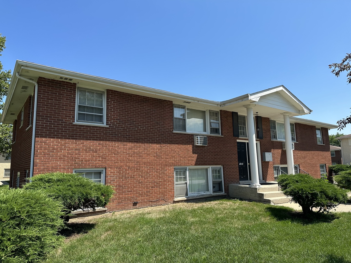 1585 West Station Street Kankakee, IL 60901 - Photo 1 of 12 a front view of a house with a yard and garage