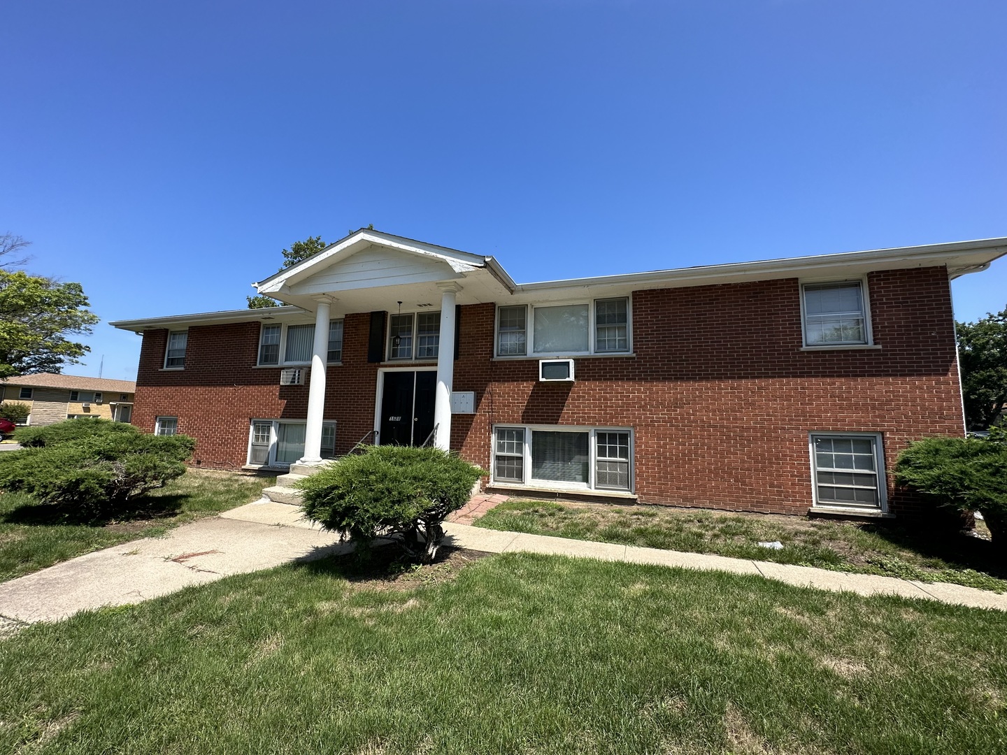 1585 West Station Street Kankakee, IL 60901 - Photo 3 of 12 a front view of a house with a yard