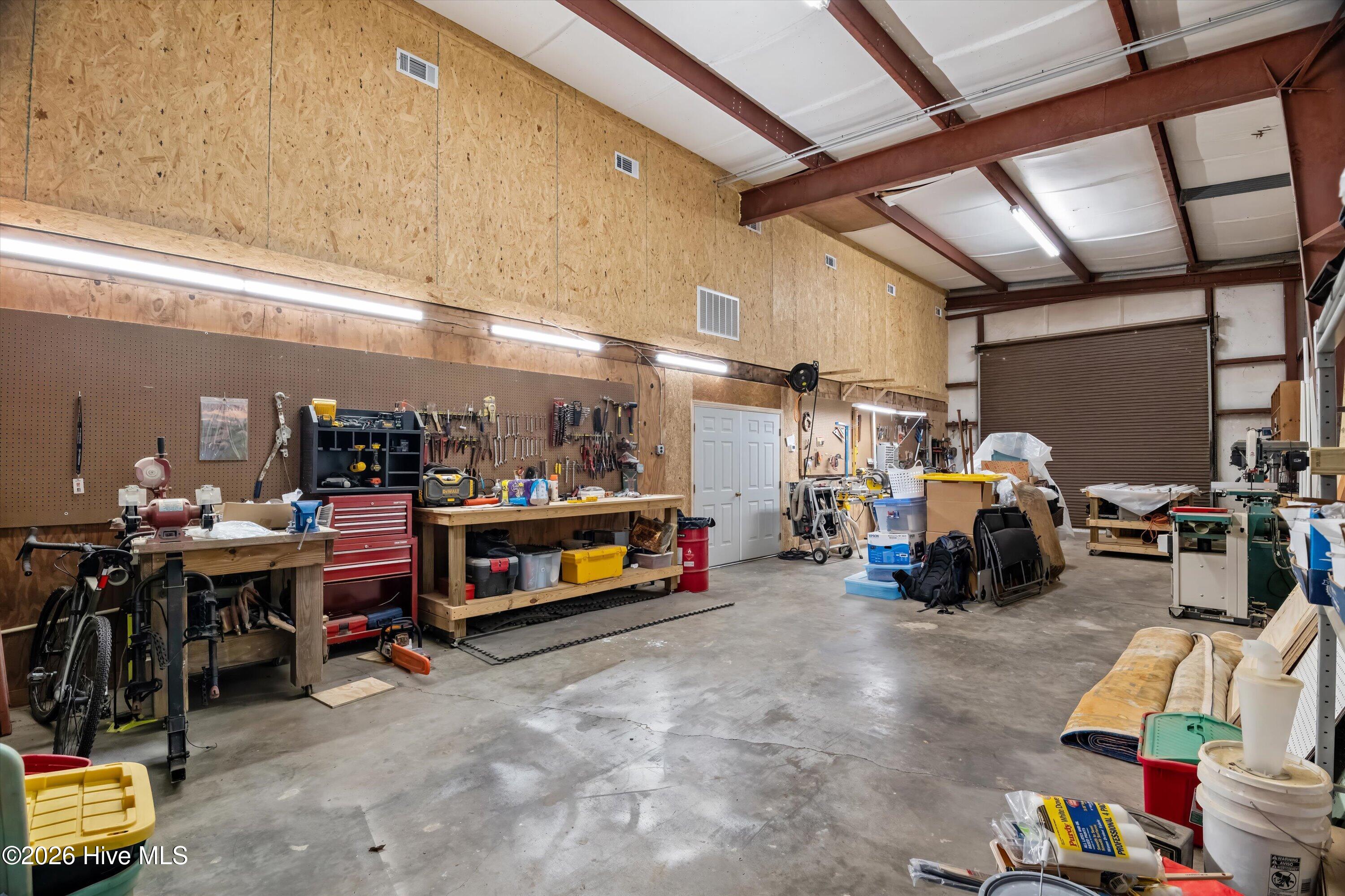 6218 Columbia Road Appling, GA 30802 - Photo 82 of 97 One side of workshop with roll up doors perfect for storing boats, RV or car collection