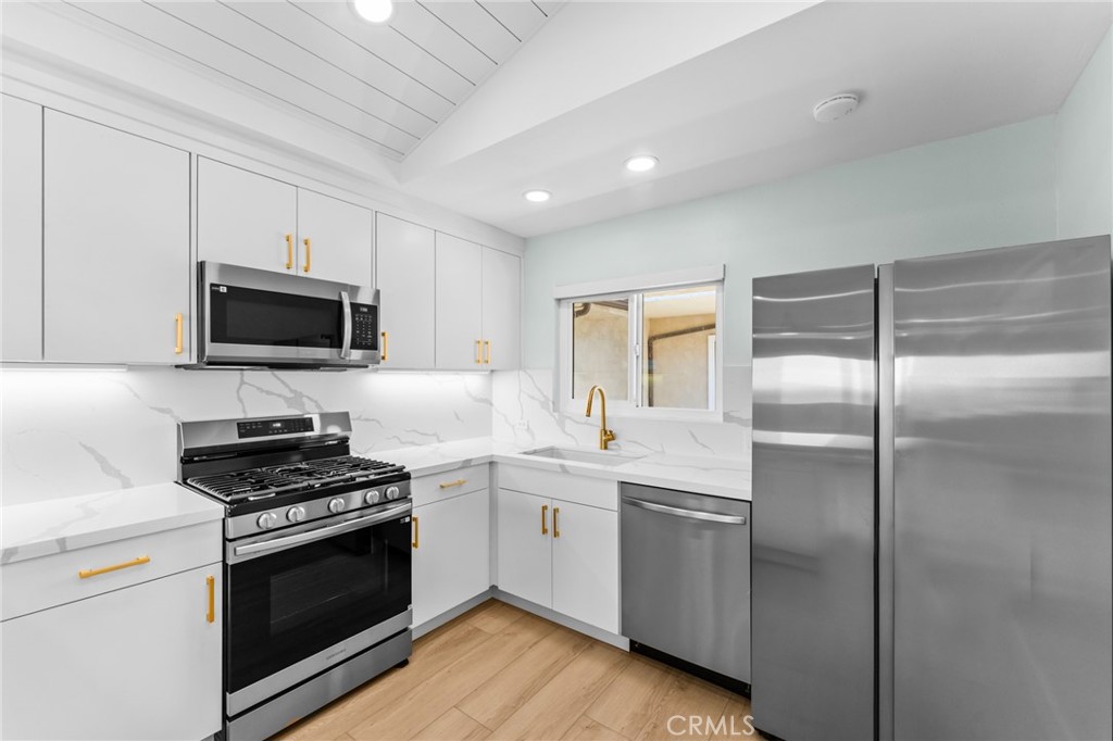 34381 Dana Strand Road, Unit 2 Dana Point, CA 92629 - Photo 14 of 32 a kitchen with a sink stove and microwave
