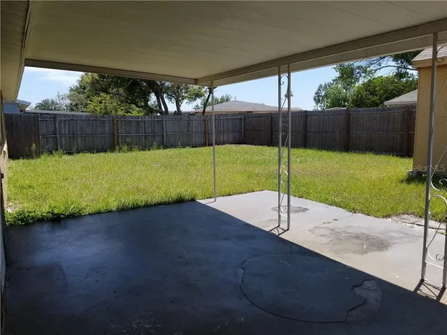 a view of a backyard with wooden fence