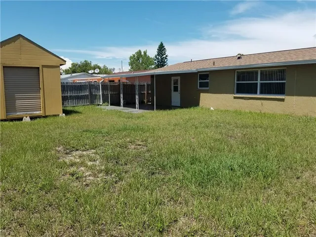 a view of a house with backyard porch and garden