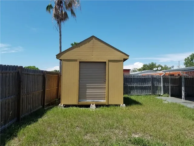 a front view of a house with a garden and yard