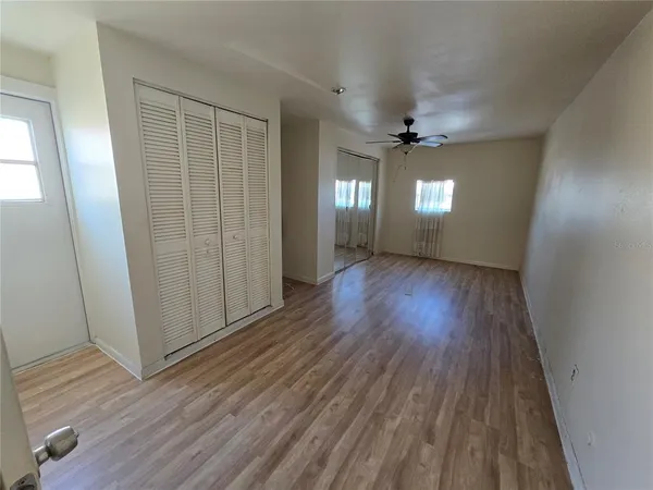 wooden floor in an empty room with a window