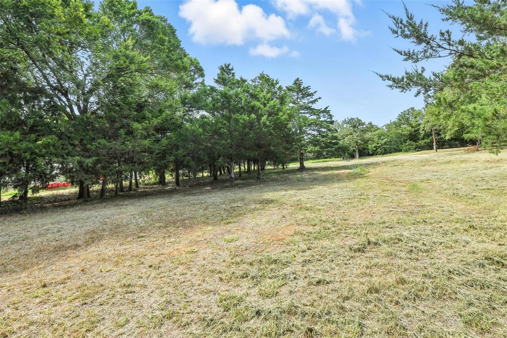 454 Bear Ridge Road Bowie, TX 76230 - Photo 29 of 36 View of green lawn featuring a view of countryside