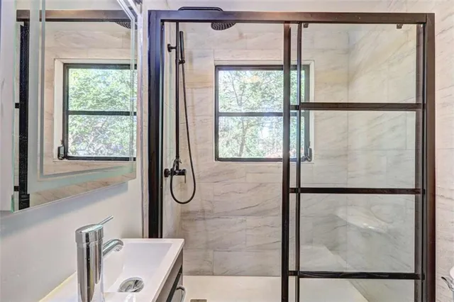 a bathroom with a glass shower door