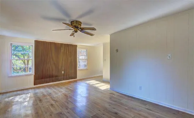 wooden floor in an empty room with a window