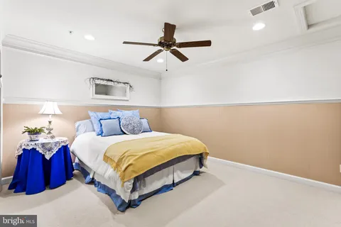 a bedroom with a bed and a ceiling fan