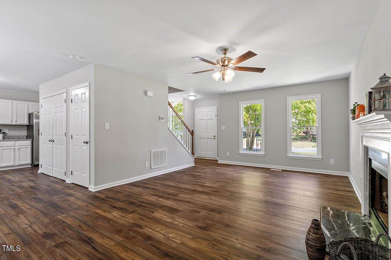 8 Warbler Lane Durham, NC 27712 - Photo 13 of 36 a view of an empty room with window hardwood floor and a ceiling fan