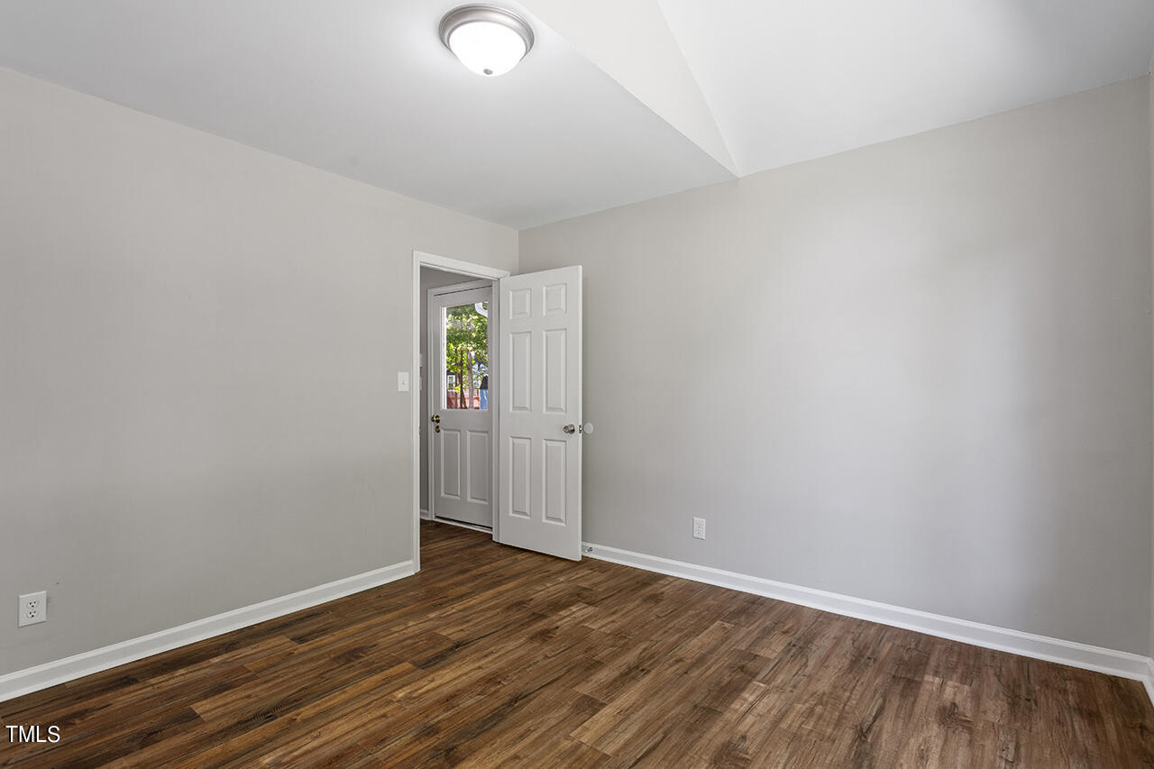 8 Warbler Lane Durham, NC 27712 - Photo 18 of 36 an empty room with wooden floor and windows