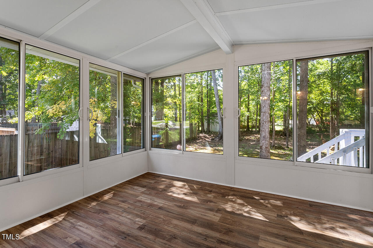 8 Warbler Lane Durham, NC 27712 - Photo 19 of 36 a view of empty room with wooden floor and windows