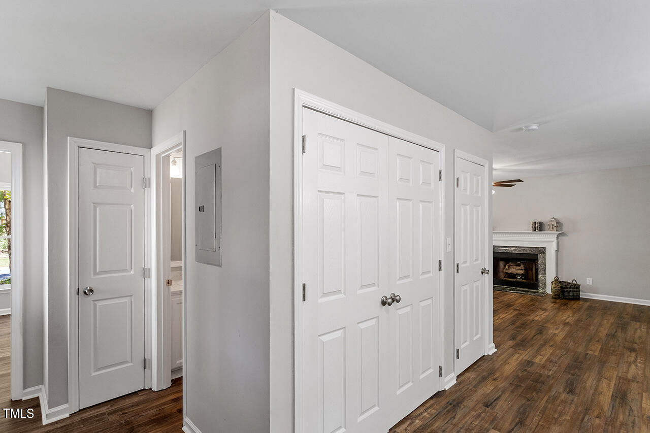 8 Warbler Lane Durham, NC 27712 - Photo 23 of 36 a view of empty room with wooden floor and fireplace