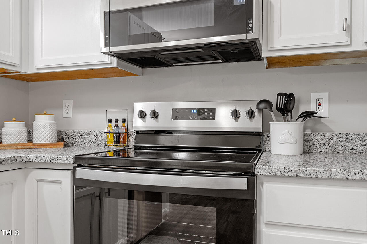 8 Warbler Lane Durham, NC 27712 - Photo 26 of 36 a stove top oven sitting inside of a kitchen