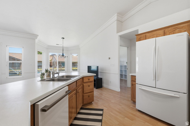 805 South River Road, Unit 70 St. George, UT 84790 - Photo 13 of 38 Kitchen featuring light wood-finish flooring, white countertops, dual basin sink, wood cabinetry, and a bay window