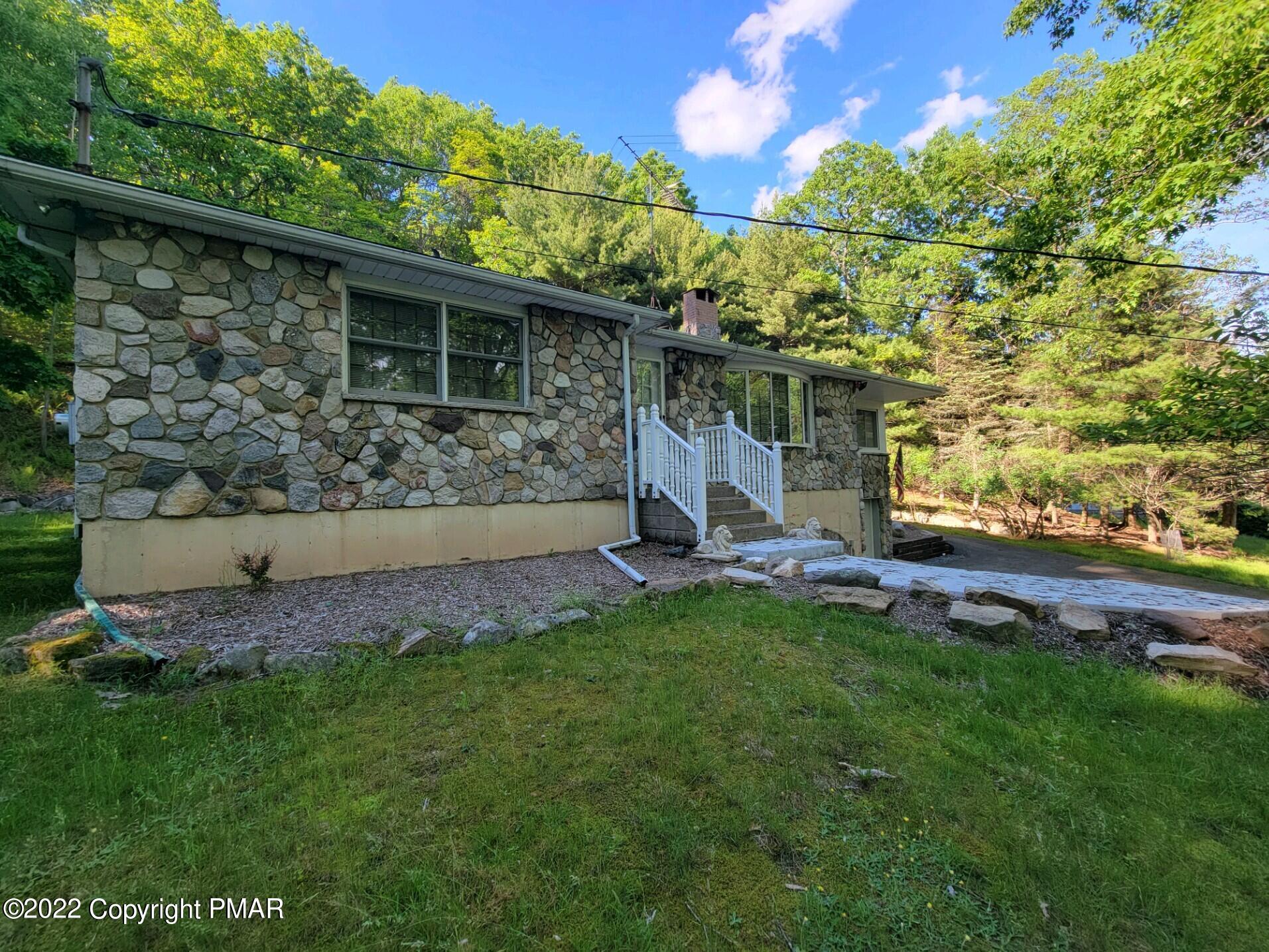 209 Grange Road Mount Pocono, PA 18344 - Photo 3 of 7 a view of a house with a backyard