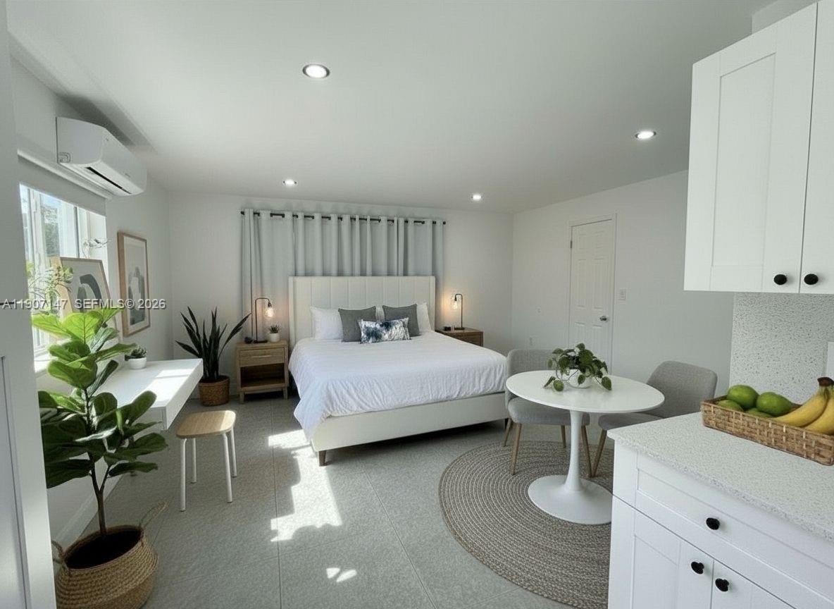 a bedroom with furniture and a potted plant