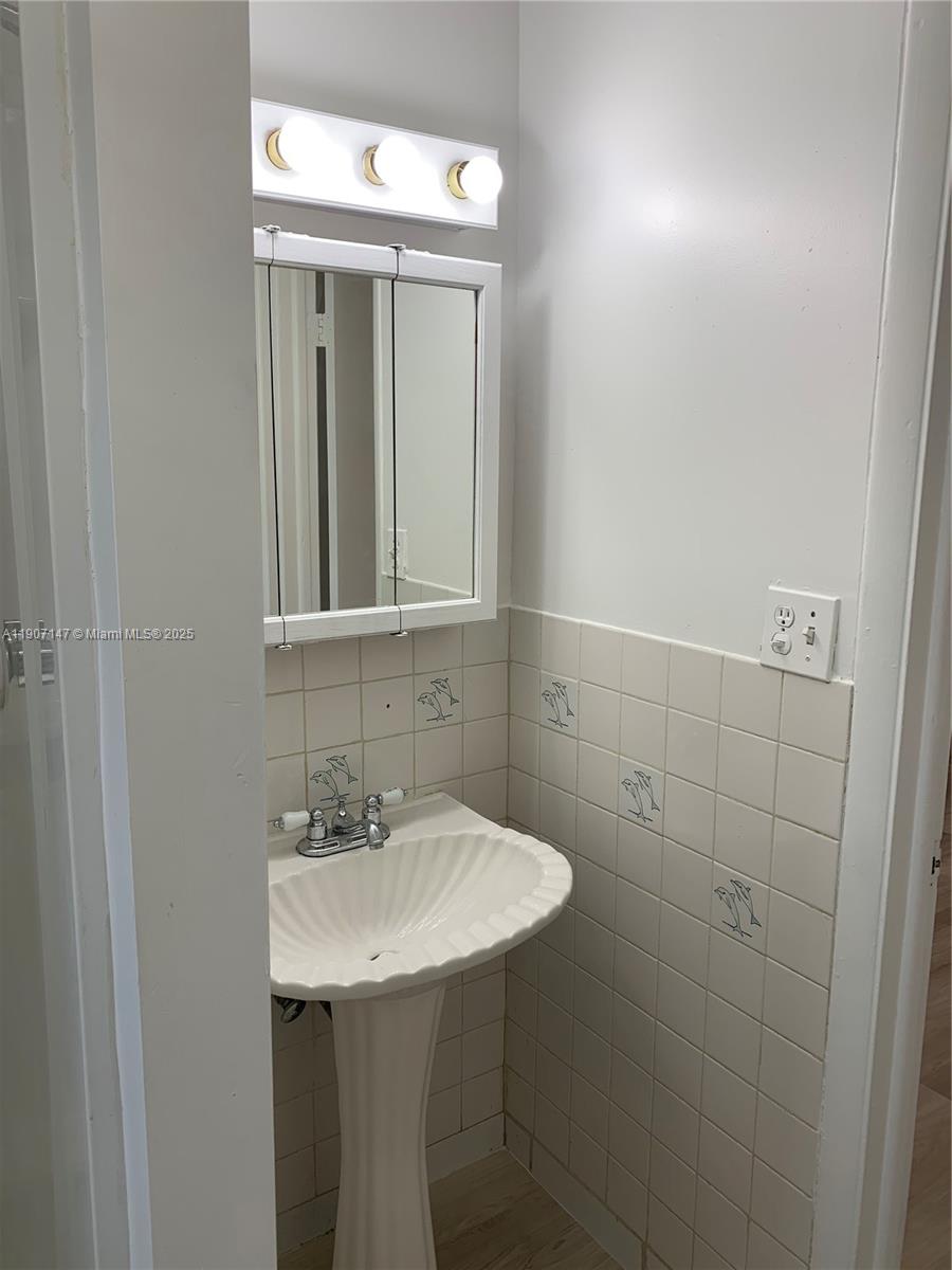10040 Southwest 198th Street Cutler Bay, FL 33157 - Photo 12 of 17 a bathroom with a sink and a mirror