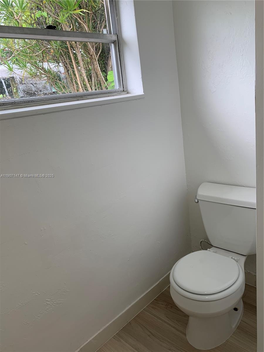 10040 Southwest 198th Street Cutler Bay, FL 33157 - Photo 13 of 17 a white toilet sitting next to a window