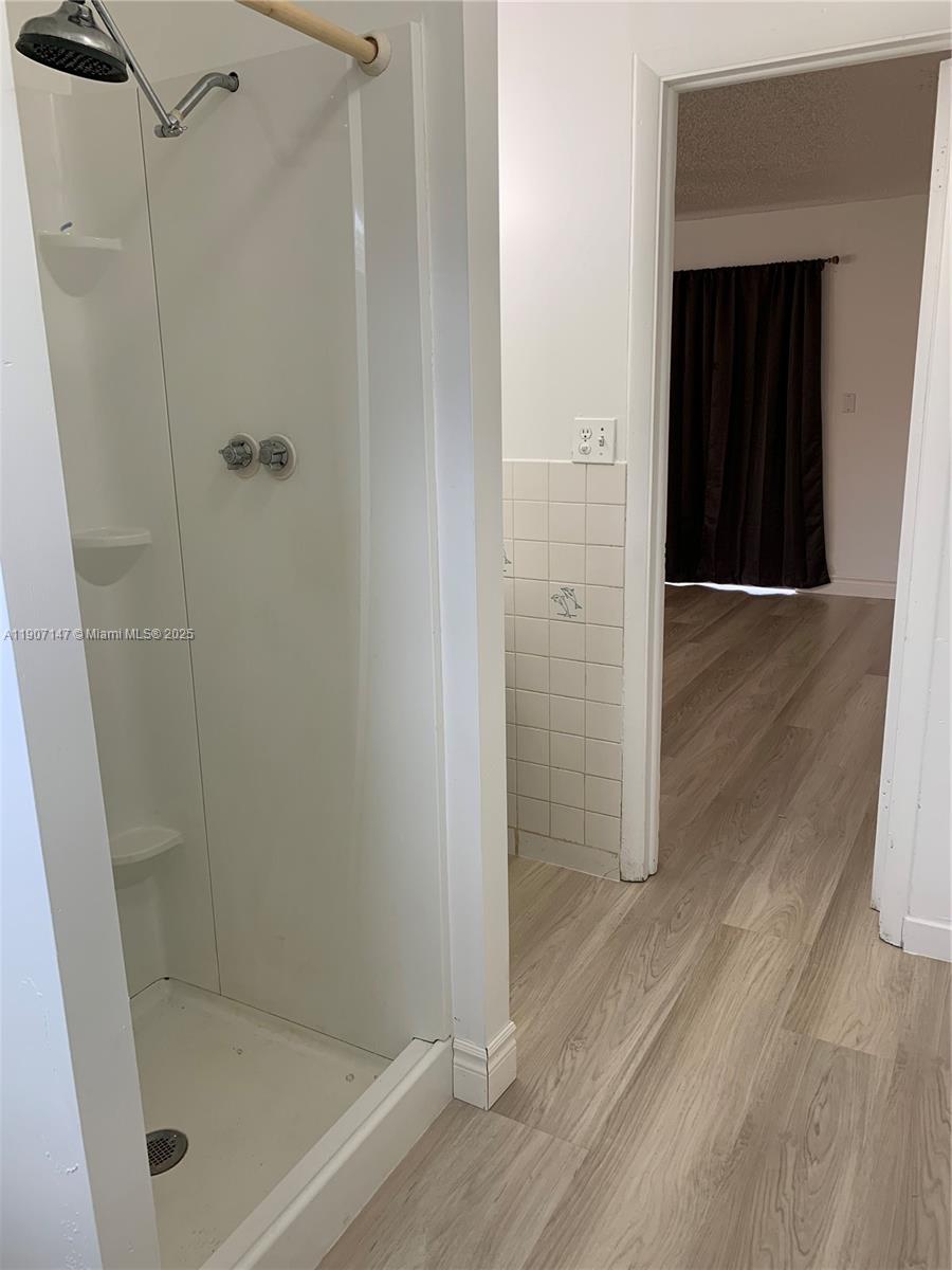 10040 Southwest 198th Street Cutler Bay, FL 33157 - Photo 14 of 17 a bathroom with a glass shower door