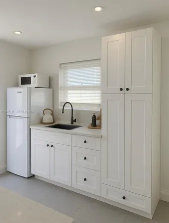 a kitchen with cabinets and white appliances