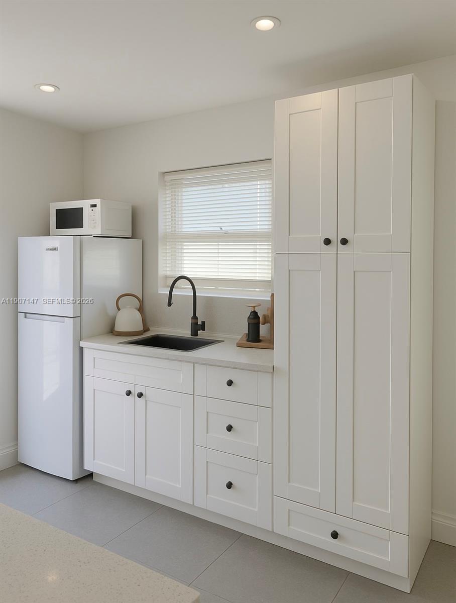 10040 Southwest 198th Street Cutler Bay, FL 33157 - Photo 3 of 13 a kitchen with cabinets and white appliances