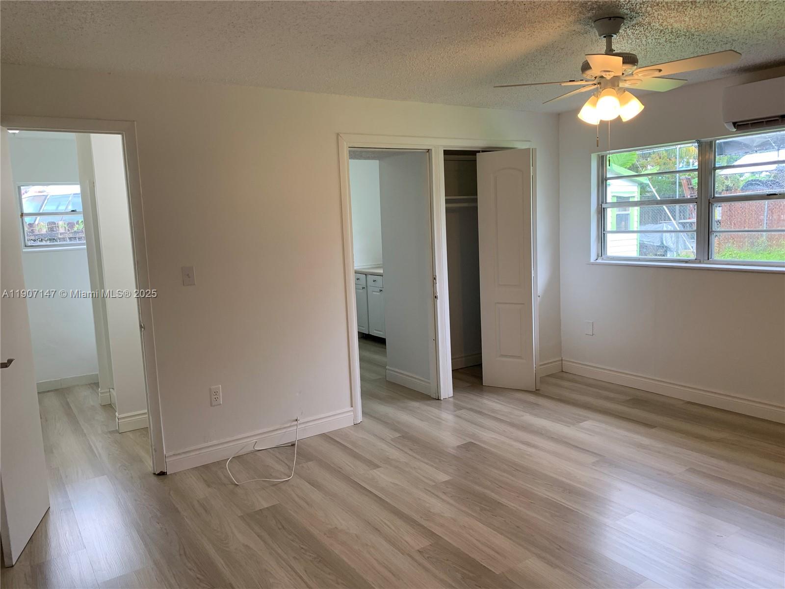 10040 Southwest 198th Street Cutler Bay, FL 33157 - Photo 3 of 17 wooden floor in an empty room with a window