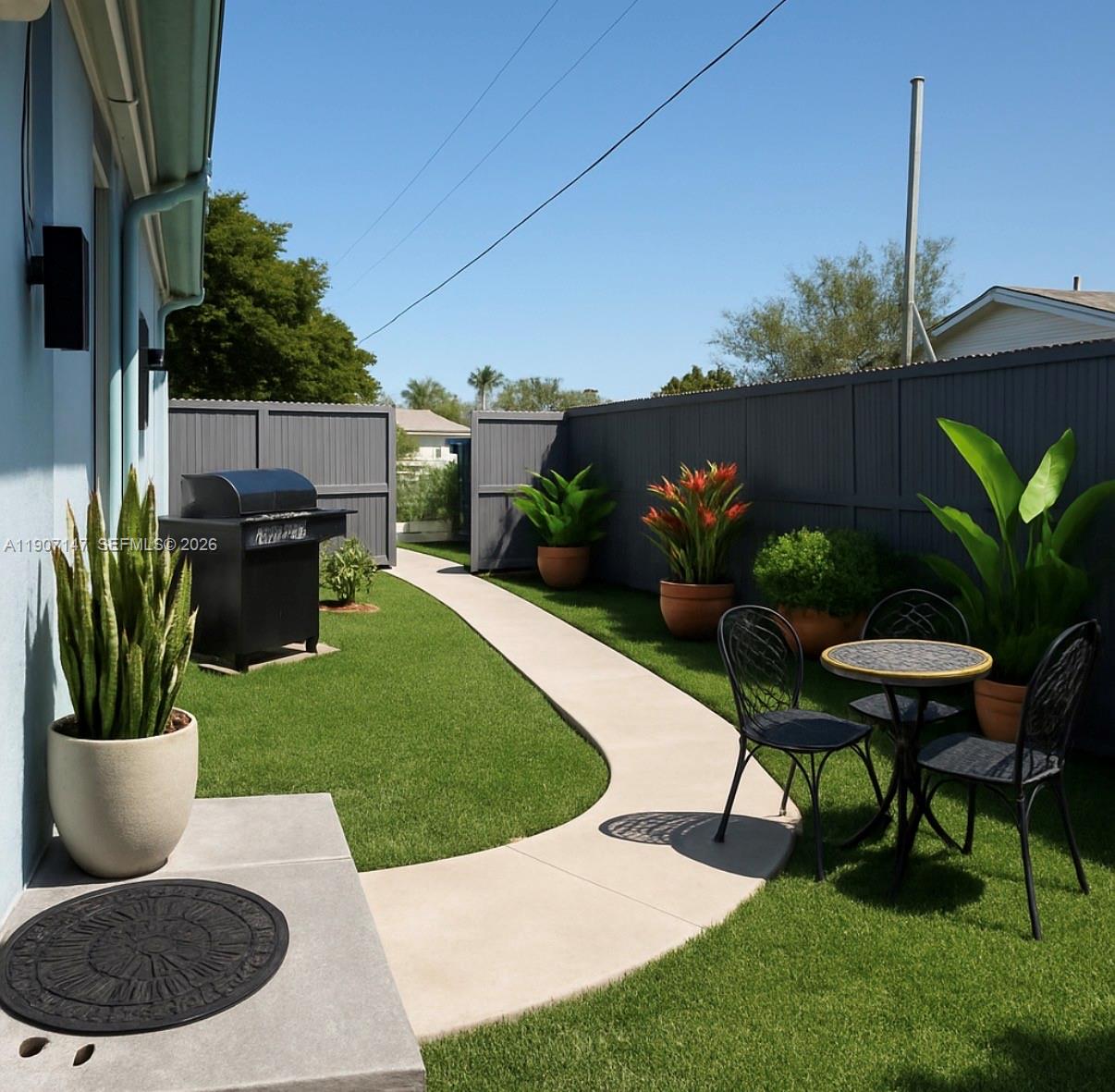 10040 Southwest 198th Street Cutler Bay, FL 33157 - Photo 4 of 13 a view of a chair and table in backyard of the house