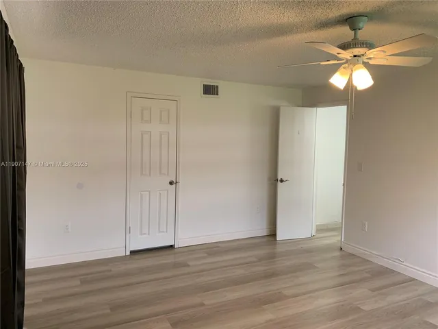 a view of a closet with wooden floor