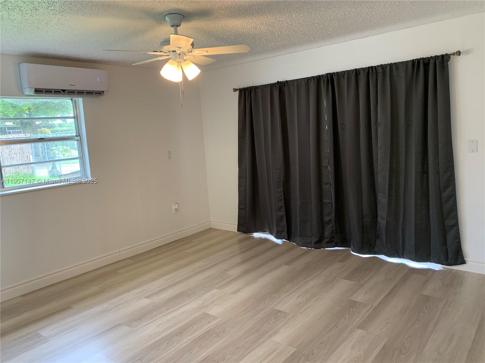 10040 Southwest 198th Street Cutler Bay, FL 33157 - Photo 6 of 17 a view of a closet with wooden floor