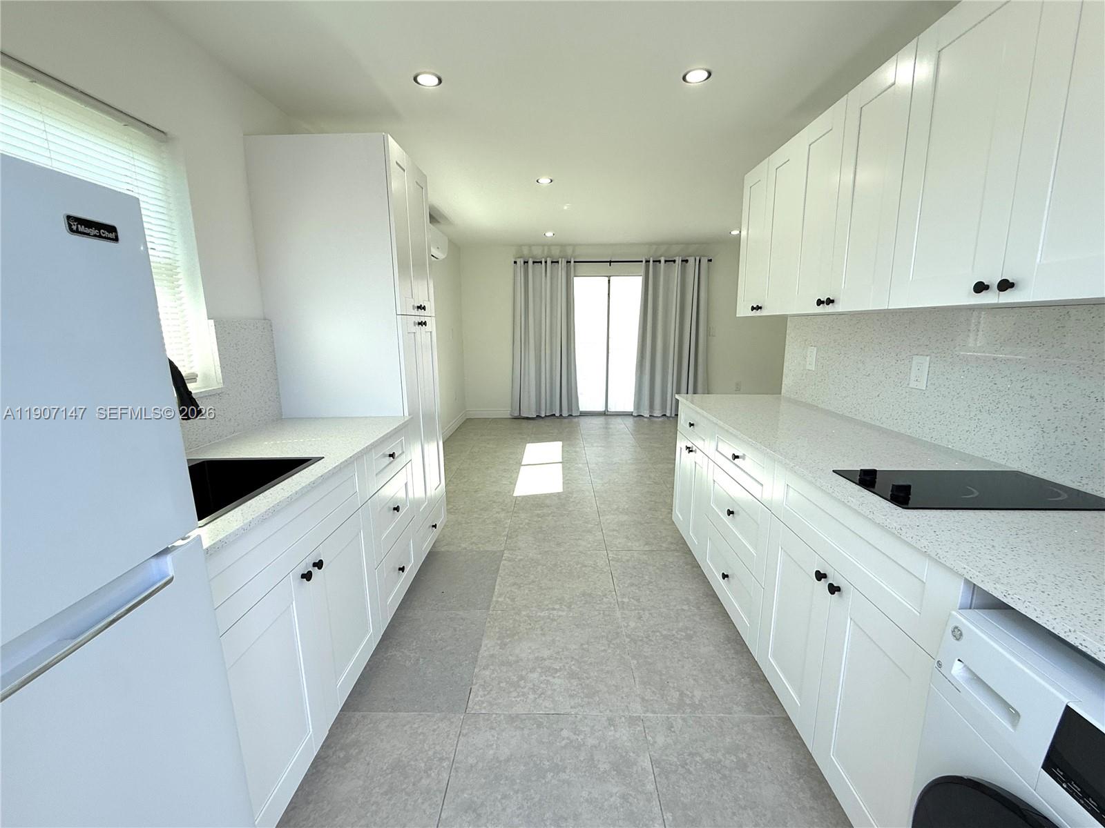 10040 Southwest 198th Street Cutler Bay, FL 33157 - Photo 6 of 13 a large white kitchen with double vanity sink and a window