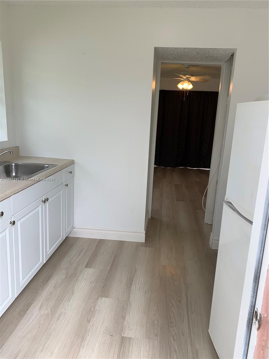 10040 Southwest 198th Street Cutler Bay, FL 33157 - Photo 9 of 17 a view of a hallway with wooden floor and closet