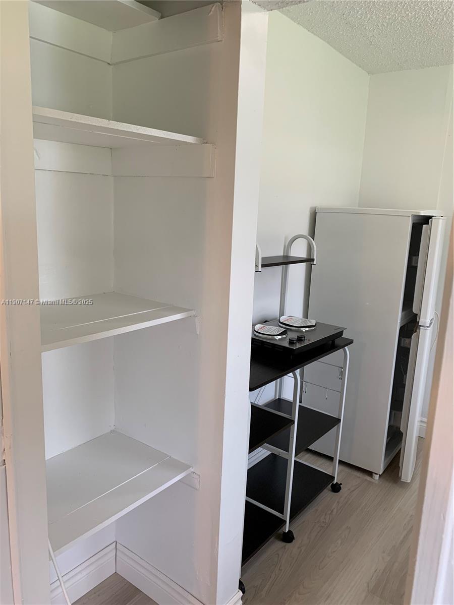 10040 Southwest 198th Street Cutler Bay, FL 33157 - Photo 10 of 17 a view of a room with racks on the wall