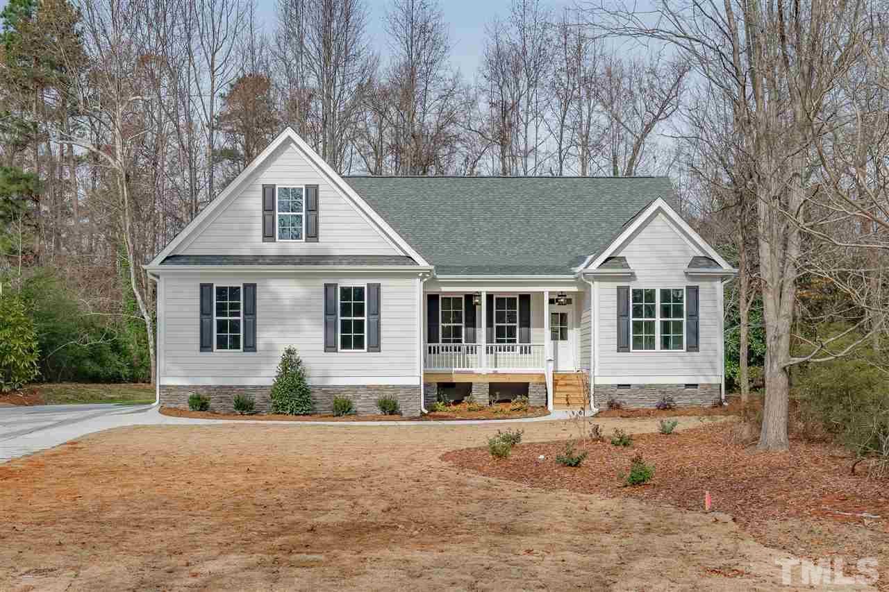 3911 Sue Lane Raleigh, NC 27604 - Photo 1 of 25 a front view of a house with a yard and garage