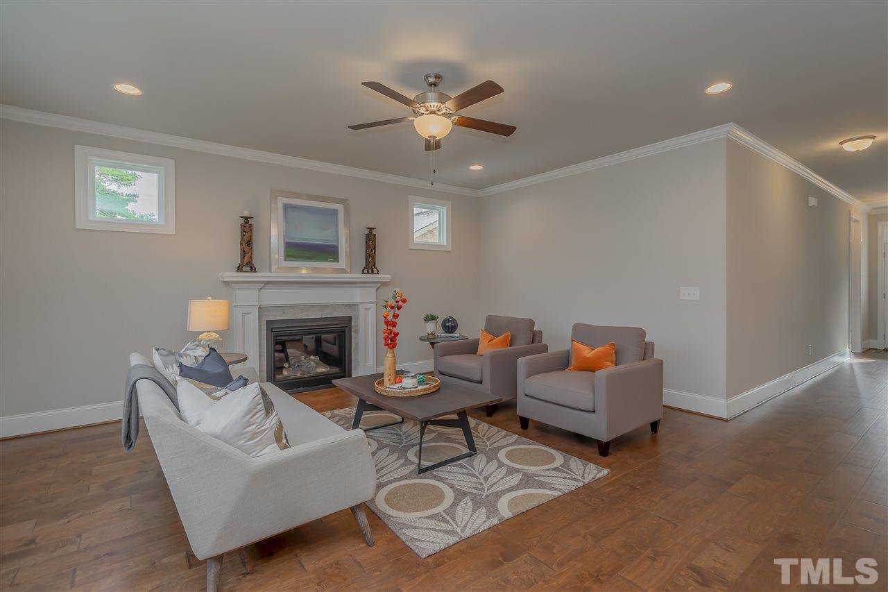 3911 Sue Lane Raleigh, NC 27604 - Photo 13 of 25 a living room with furniture and a fireplace