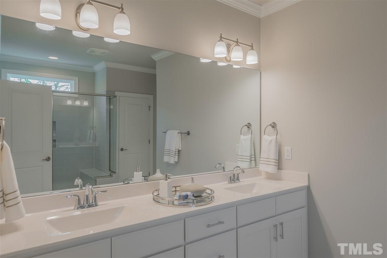 3911 Sue Lane Raleigh, NC 27604 - Photo 18 of 25 a bathroom with a sink double vanity and a mirror