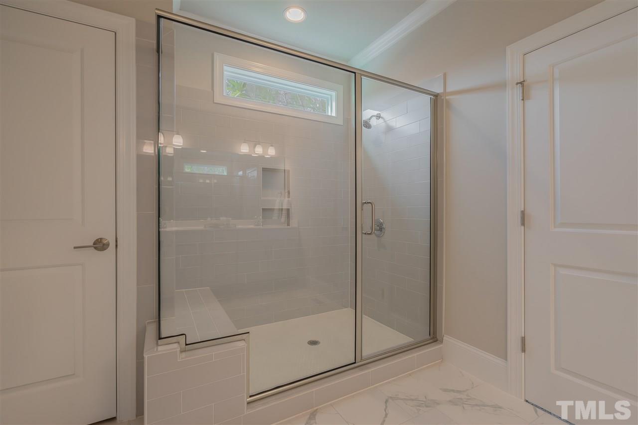 3911 Sue Lane Raleigh, NC 27604 - Photo 19 of 25 a bathroom with a glass shower door