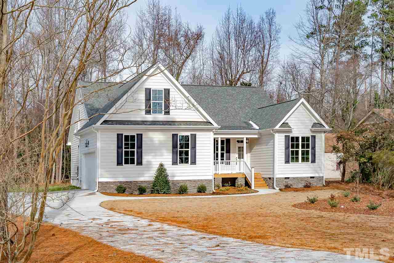 3911 Sue Lane Raleigh, NC 27604 - Photo 25 of 25 a front view of a house with a yard covered in snow