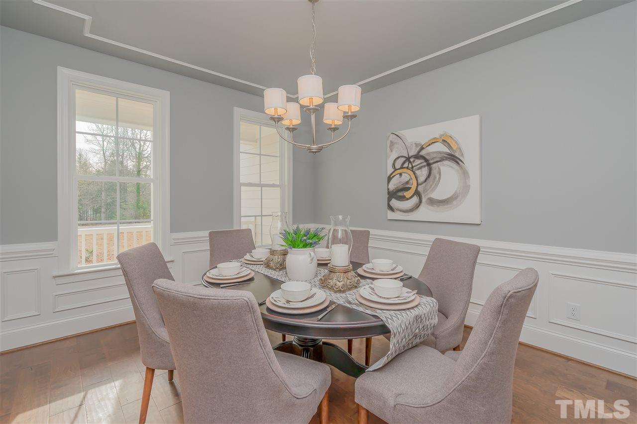 3911 Sue Lane Raleigh, NC 27604 - Photo 4 of 25 a view of a dining room with furniture wooden floor and a chandelier