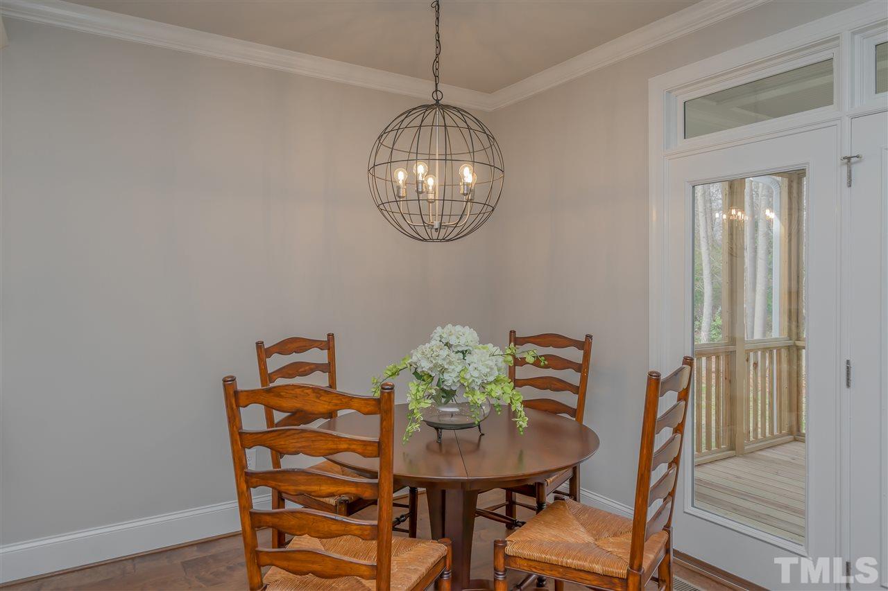 3911 Sue Lane Raleigh, NC 27604 - Photo 10 of 25 a view of a dining room with furniture and wooden floor
