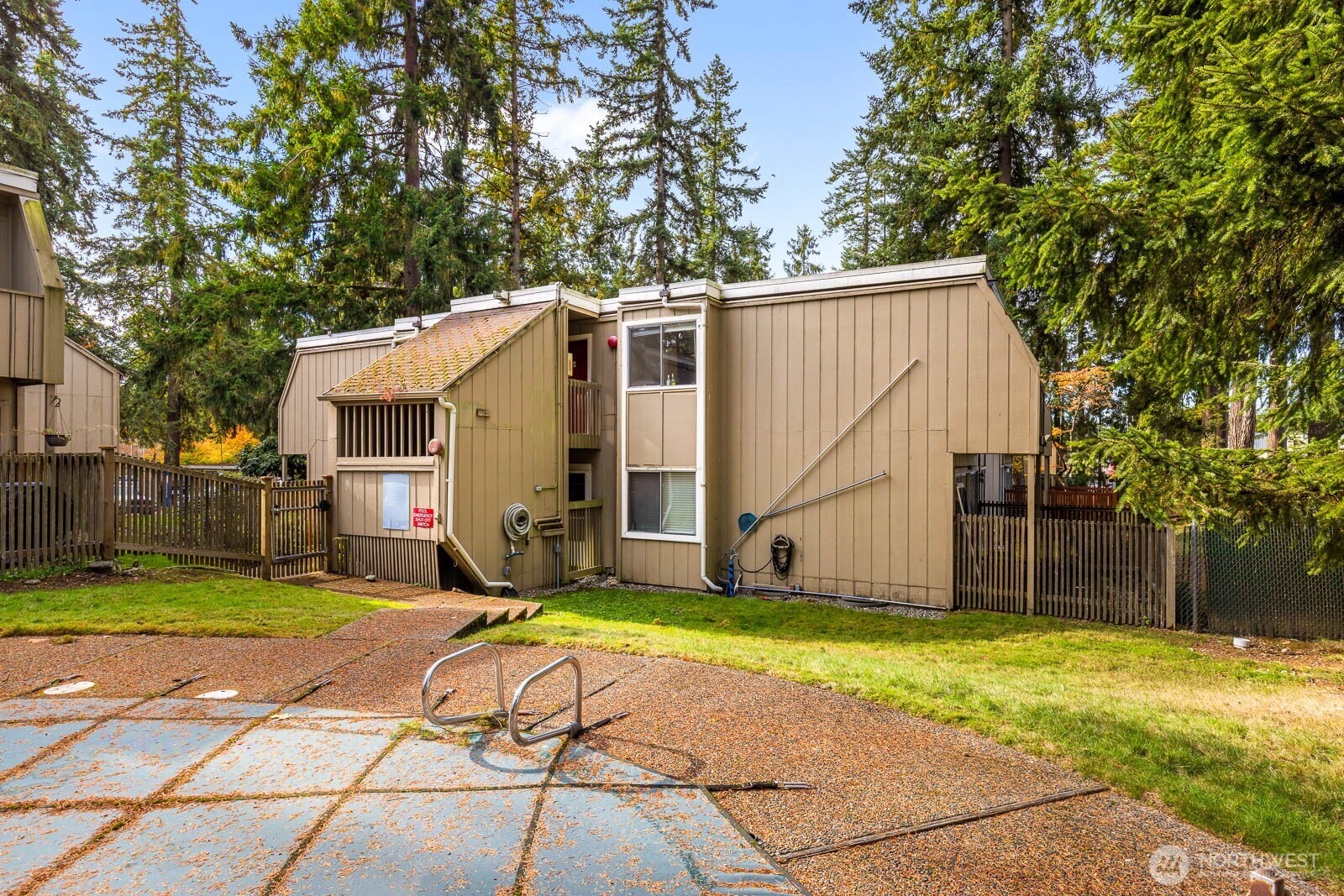 4823 180th Street Southwest, Unit H203 Lynnwood, WA 98037 - Photo 25 of 26 a view of a backyard with a large tree