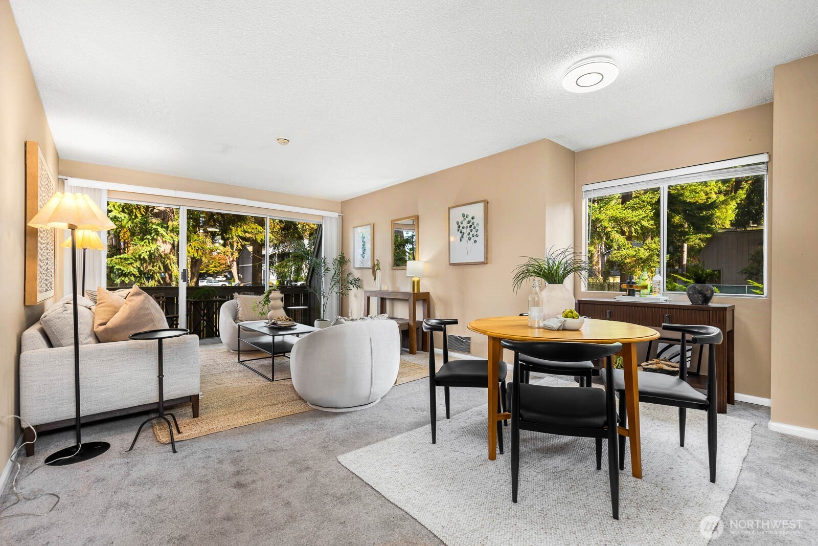 4823 180th Street Southwest, Unit H203 Lynnwood, WA 98037 - Photo 8 of 26 a living room with furniture a large window and a table