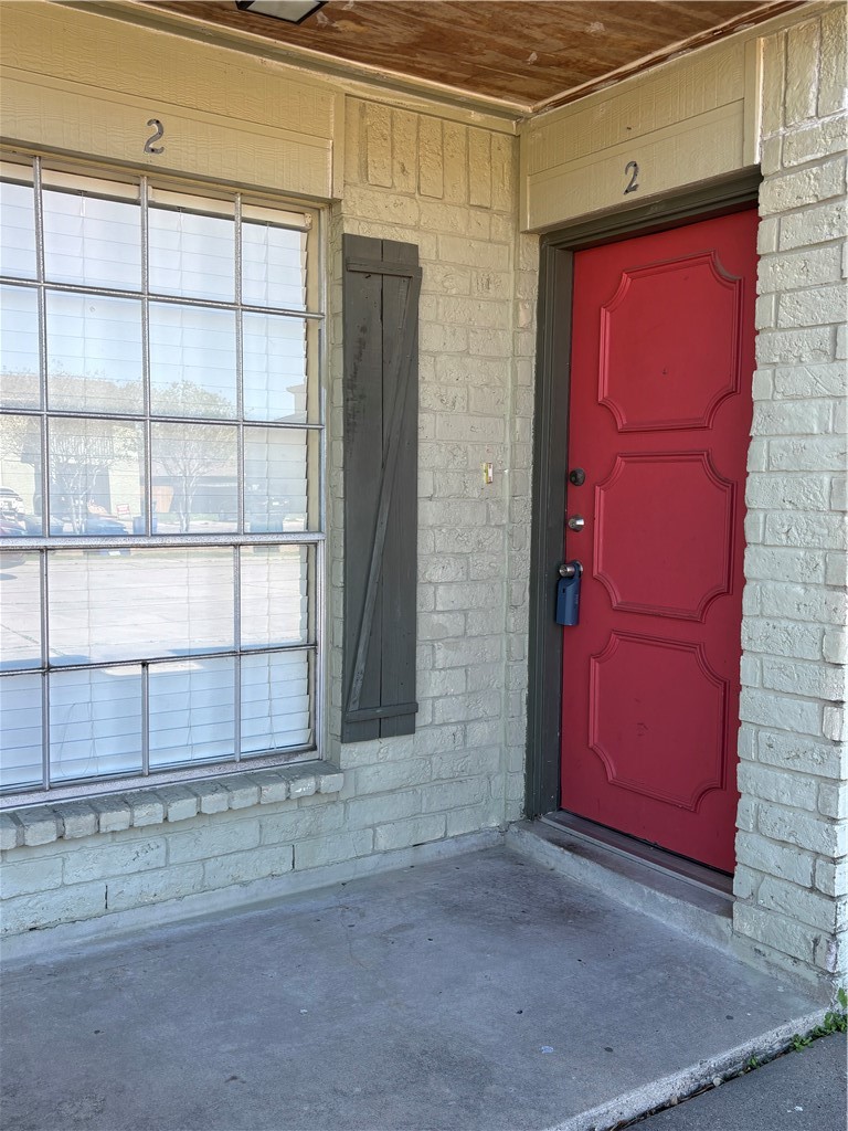 7214 Owen Court, Unit 2 Corpus Christi, TX 78413 - Photo 1 of 18 a view of a red door of the house