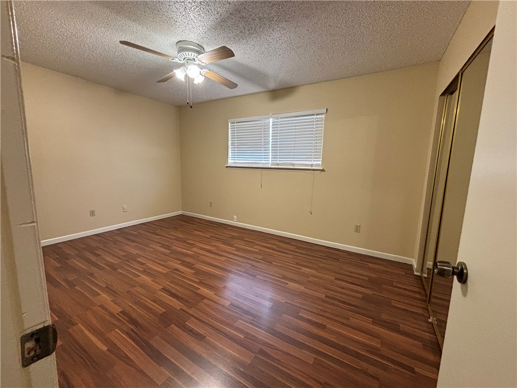 7214 Owen Court, Unit 2 Corpus Christi, TX 78413 - Photo 12 of 18 a view of a room with wooden floor and a ceiling fan